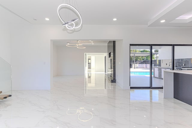 unfurnished room featuring marble finish floor, baseboards, and recessed lighting