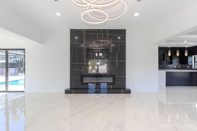 interior space featuring baseboards, marble finish floor, a tiled fireplace, and recessed lighting