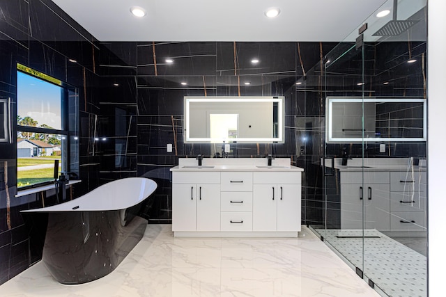 bathroom featuring double vanity, marble finish floor, a freestanding bath, and a sink