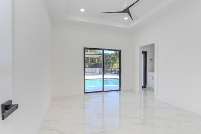 empty room with a ceiling fan, recessed lighting, marble finish floor, and baseboards