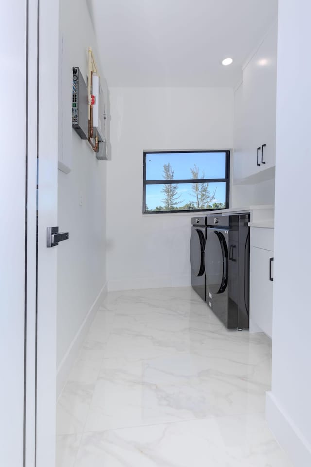 washroom with recessed lighting, baseboards, marble finish floor, cabinet space, and washer and clothes dryer