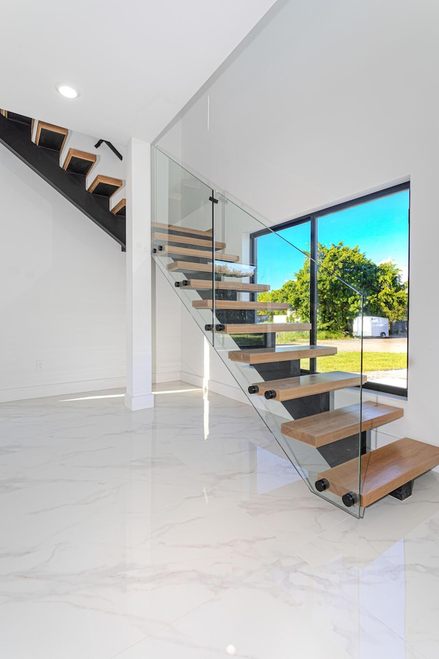 staircase featuring recessed lighting and marble finish floor