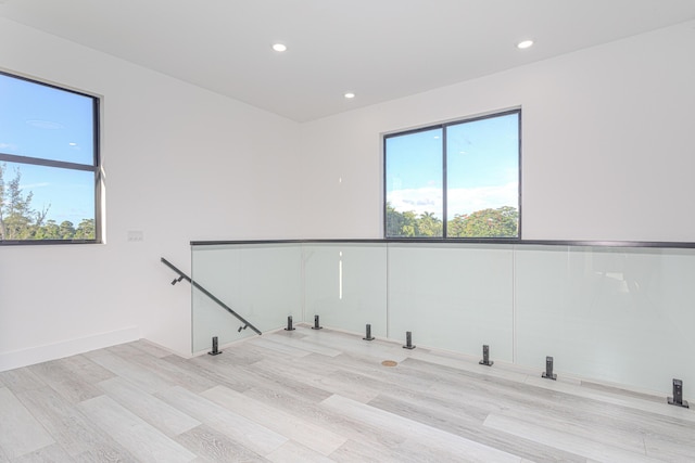 spare room featuring light wood-style flooring and recessed lighting