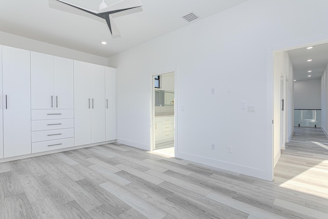 unfurnished bedroom featuring light wood-style floors, recessed lighting, visible vents, and connected bathroom