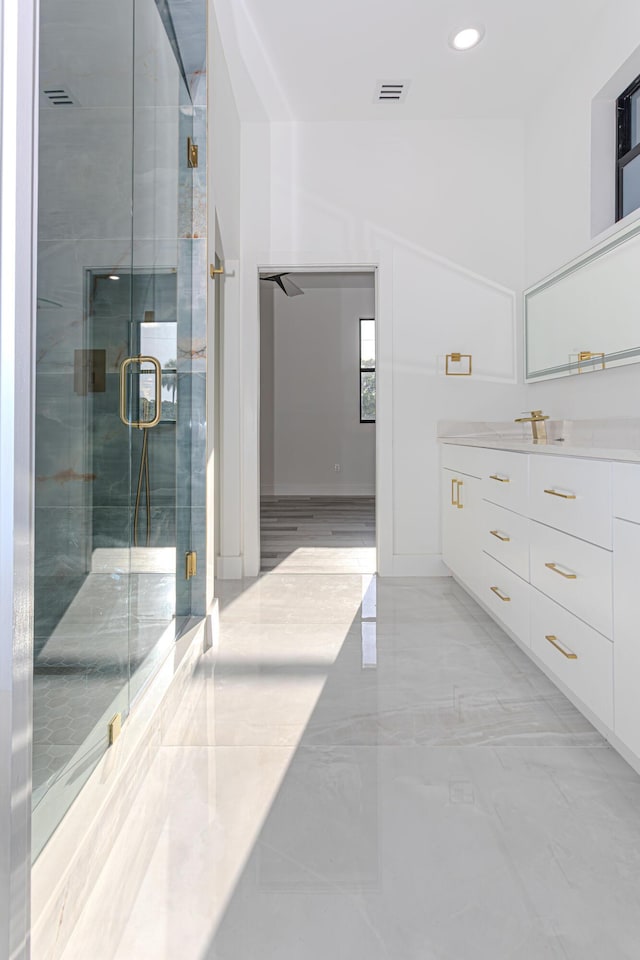 bathroom with marble finish floor, recessed lighting, visible vents, vanity, and a shower stall