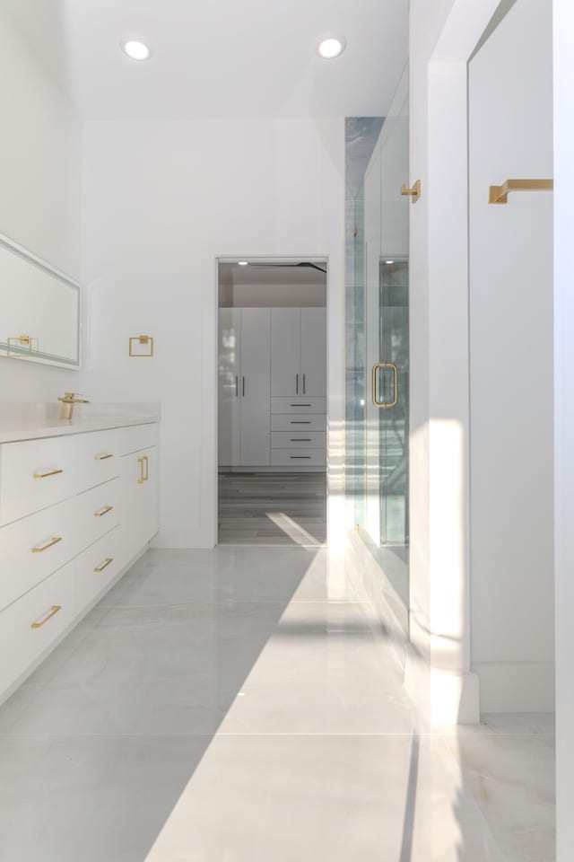 bathroom featuring recessed lighting, vanity, and a shower stall