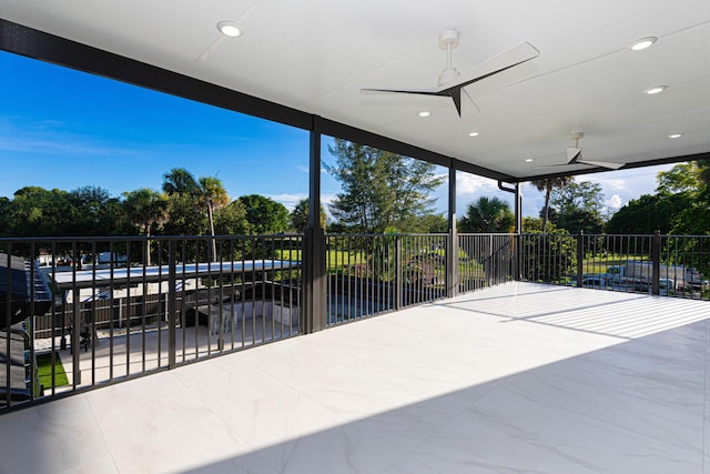 view of patio with fence and a ceiling fan