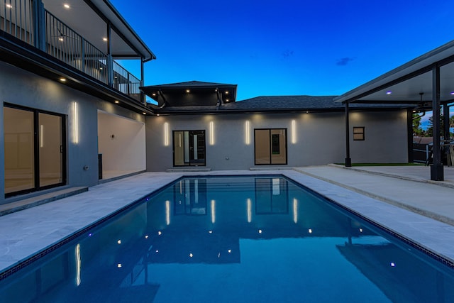 pool featuring a ceiling fan and a patio