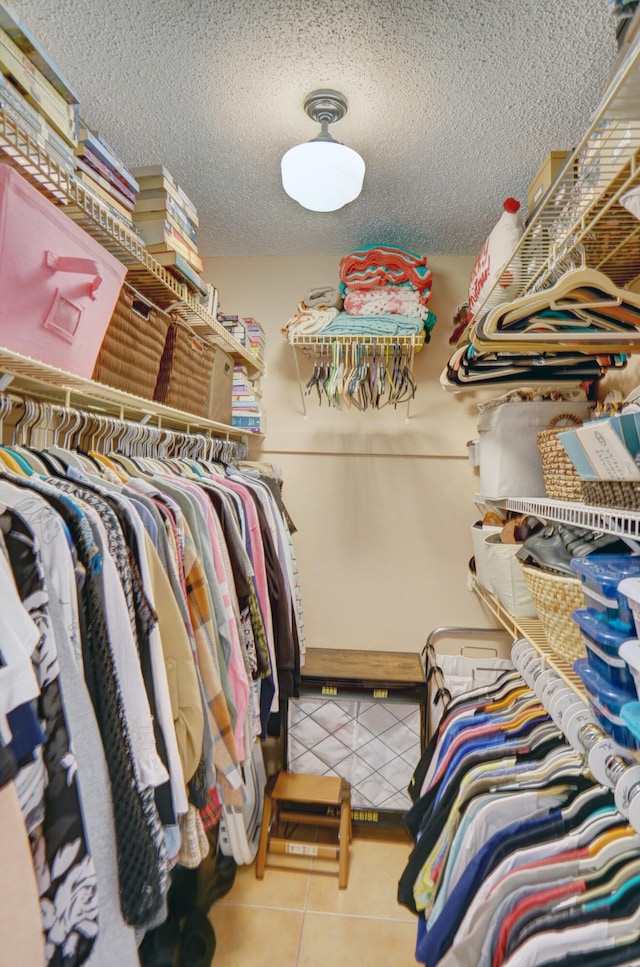 spacious closet with light tile patterned floors