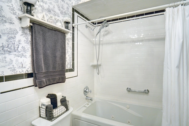 bathroom with shower / bath combo with shower curtain, toilet, and tile walls