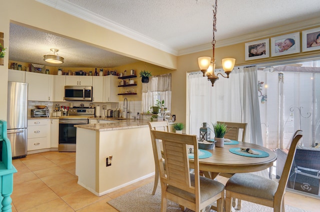 dining space with sink, a textured ceiling, a chandelier, and light tile patterned floors