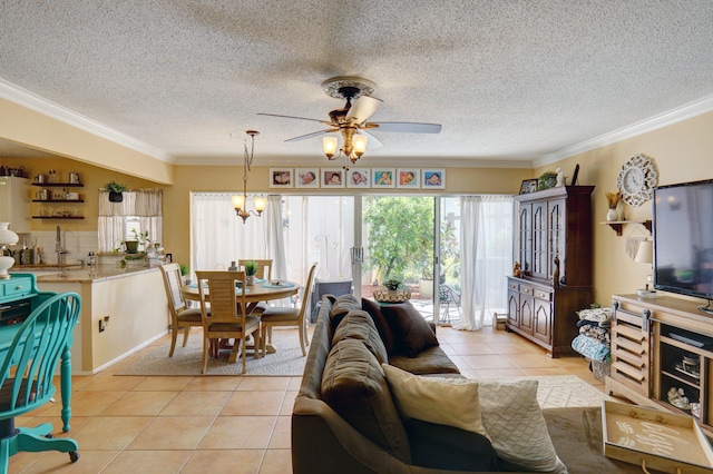 living room with ceiling fan with notable chandelier, ornamental molding, light tile patterned floors, and a textured ceiling