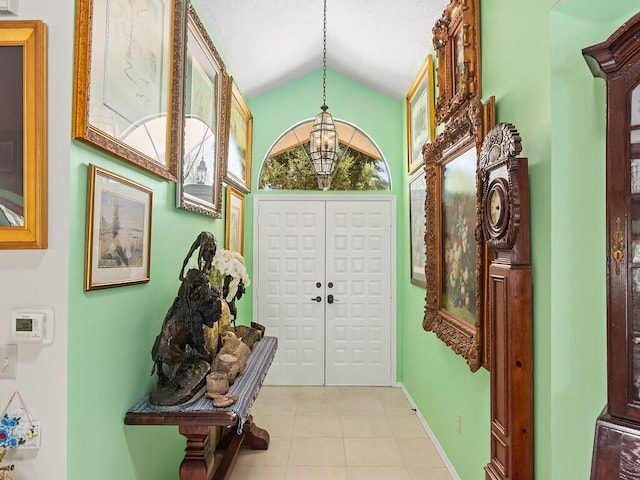 interior space featuring vaulted ceiling and light tile patterned floors