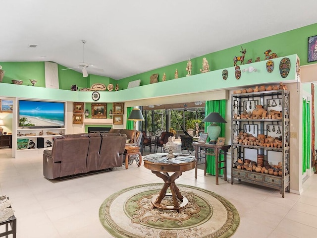 tiled living room with ceiling fan and high vaulted ceiling