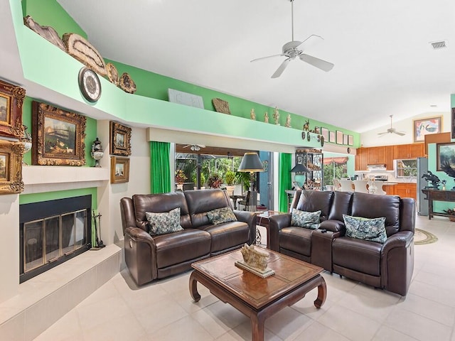 tiled living room featuring lofted ceiling and ceiling fan