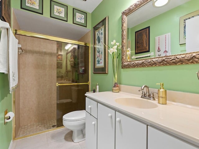 bathroom featuring a shower with door, vanity, tile patterned flooring, and toilet