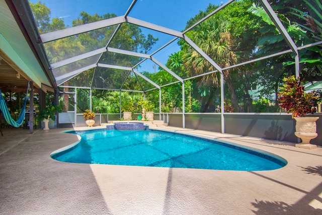 view of swimming pool with a patio area and a lanai