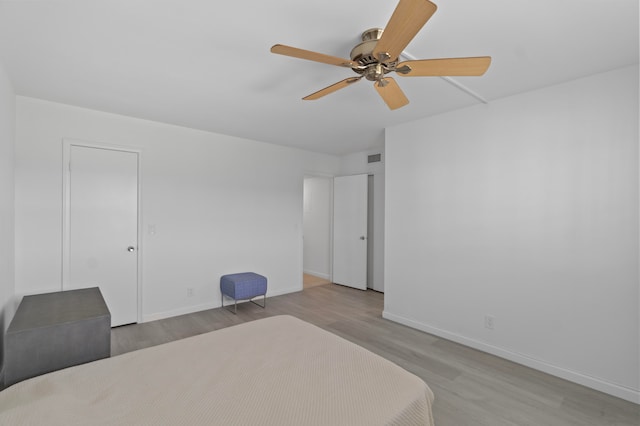 bedroom with ceiling fan and light hardwood / wood-style floors