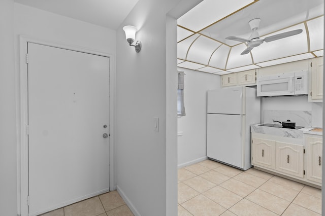 kitchen with ceiling fan, light tile patterned floors, and white appliances