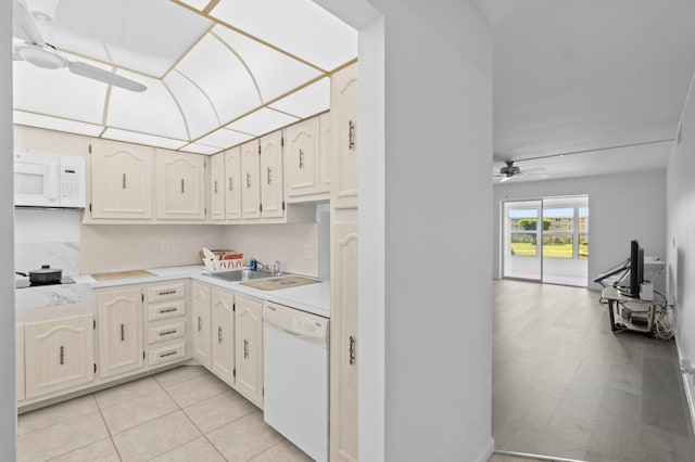 kitchen featuring sink, light tile patterned floors, ceiling fan, and white appliances