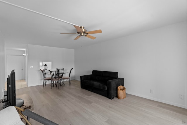 living room featuring light hardwood / wood-style flooring and ceiling fan