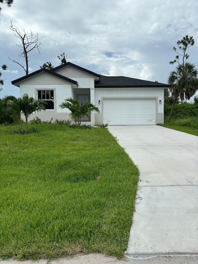 ranch-style home featuring a front yard and a garage