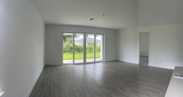 unfurnished room with dark hardwood / wood-style floors