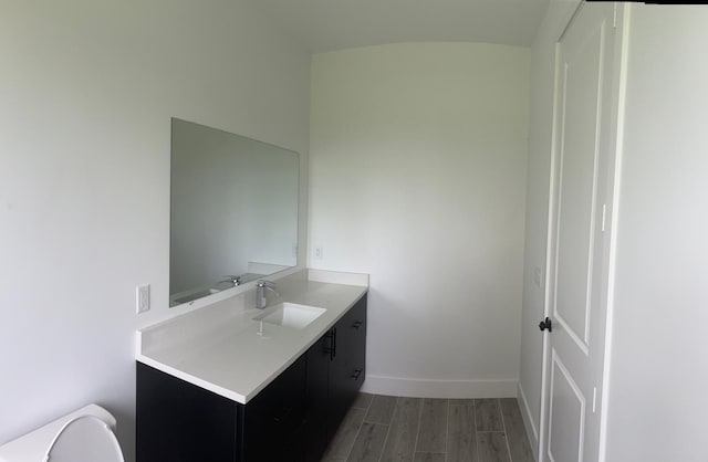 bathroom featuring vanity, toilet, and wood-type flooring