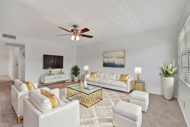 carpeted living room featuring ceiling fan