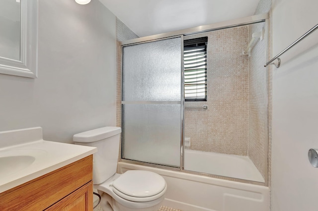 full bathroom with toilet, combined bath / shower with glass door, and vanity