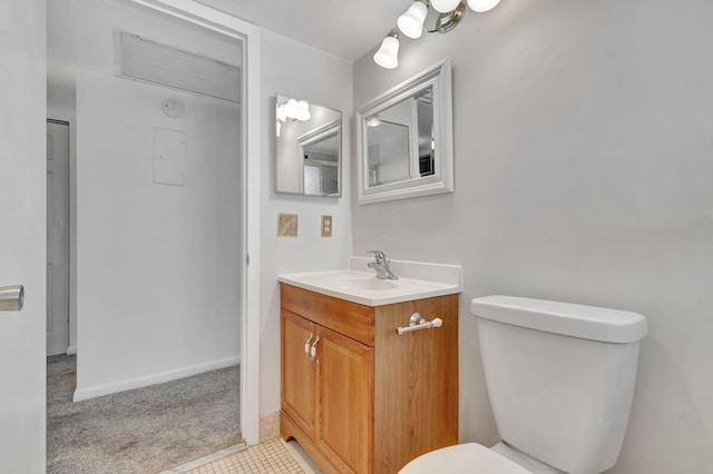 bathroom featuring tile patterned flooring, vanity, and toilet