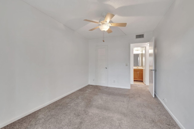 unfurnished room featuring ceiling fan and light colored carpet