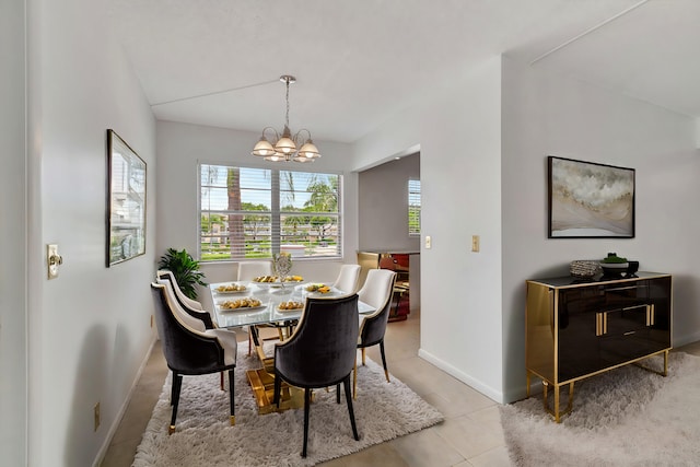 tiled dining area featuring a notable chandelier