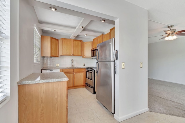 kitchen with appliances with stainless steel finishes, light brown cabinetry, sink, light tile patterned floors, and beam ceiling