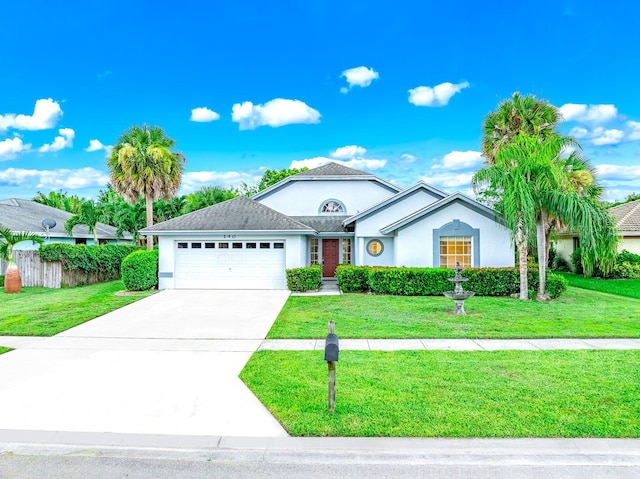 ranch-style house featuring a garage and a front lawn