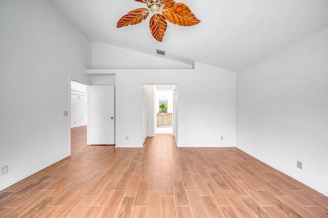 spare room featuring high vaulted ceiling, a textured ceiling, light hardwood / wood-style floors, and ceiling fan