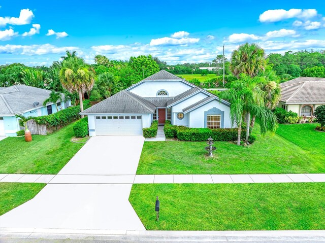 view of front facade with a garage and a front lawn