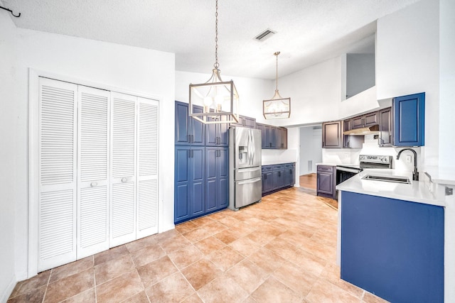 kitchen featuring blue cabinets, sink, hanging light fixtures, a textured ceiling, and appliances with stainless steel finishes