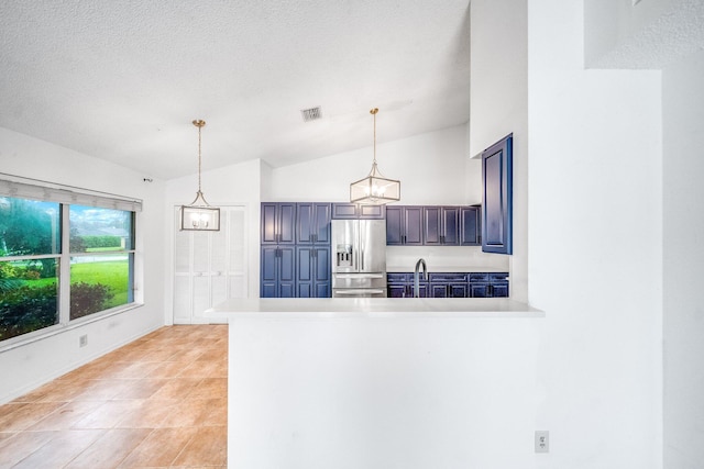 kitchen featuring pendant lighting, stainless steel fridge with ice dispenser, lofted ceiling, and kitchen peninsula