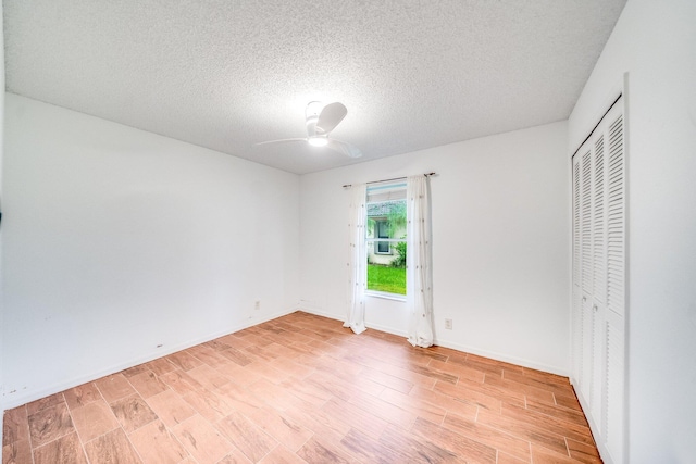 unfurnished bedroom featuring a textured ceiling, light hardwood / wood-style floors, a closet, and ceiling fan