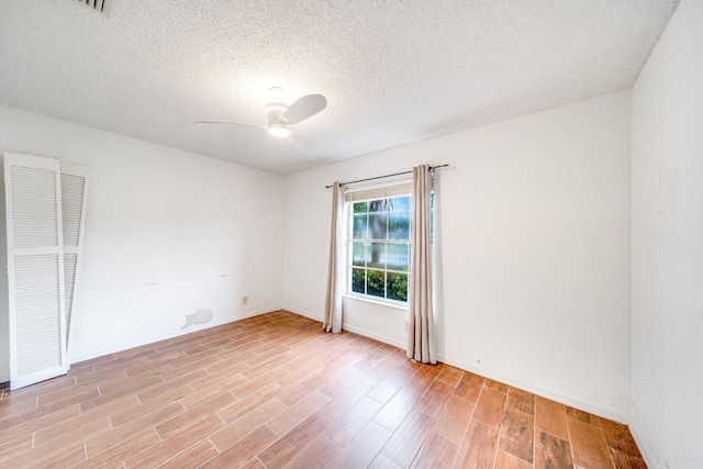 spare room with ceiling fan and a textured ceiling