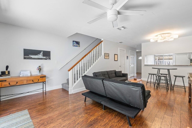 living room featuring wood-type flooring and ceiling fan