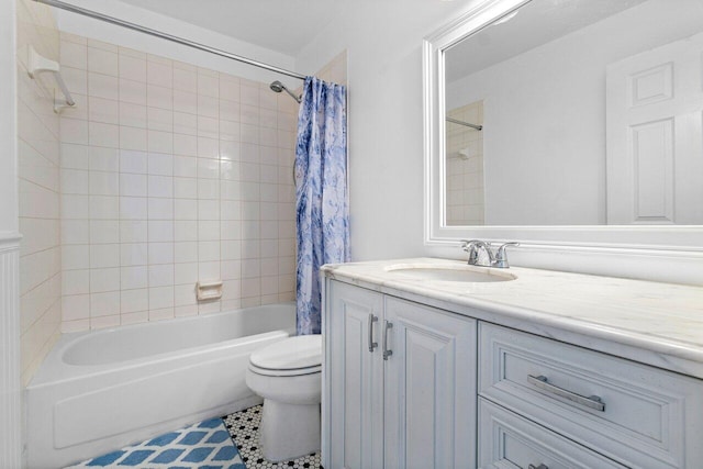 full bathroom with tile patterned floors, shower / bathtub combination with curtain, toilet, and vanity