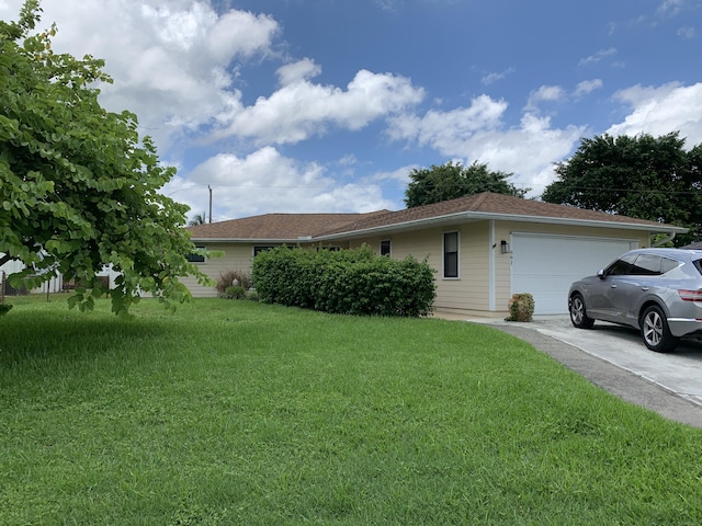 ranch-style house featuring a garage and a front lawn