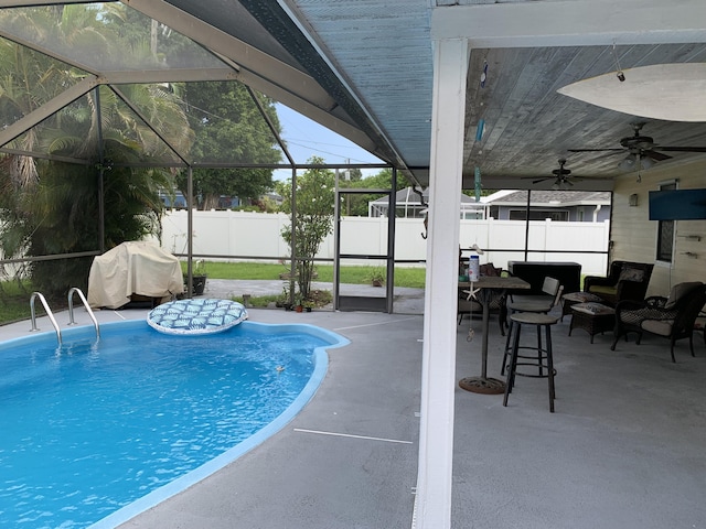 view of swimming pool featuring a lanai, a patio, and ceiling fan