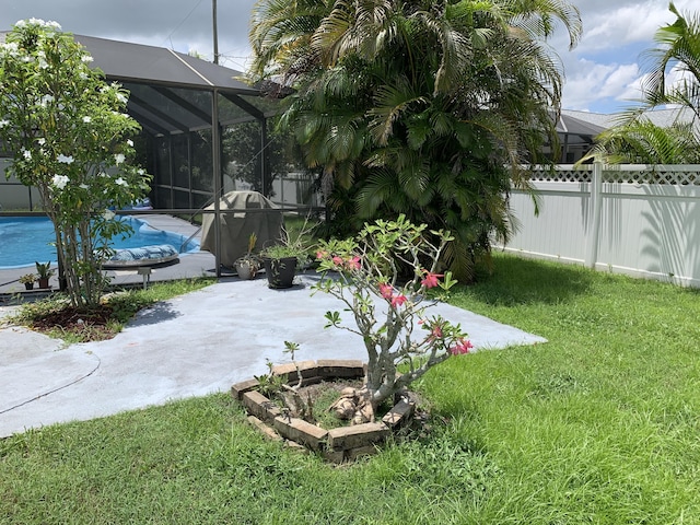 view of yard featuring a lanai, a patio area, and a covered pool