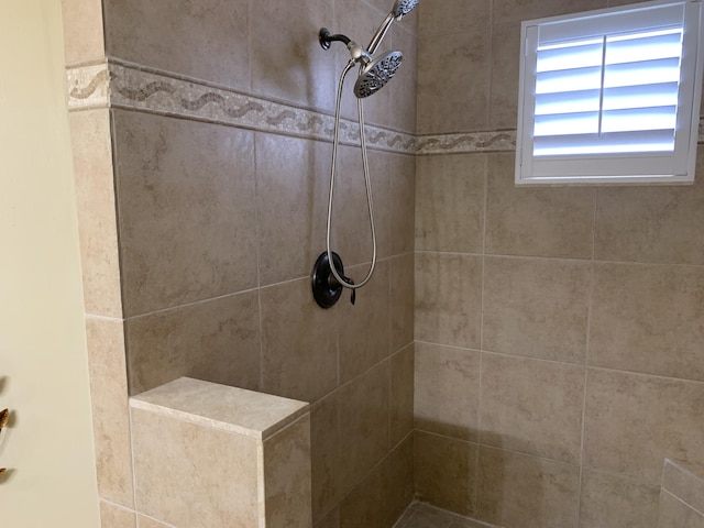 bathroom with tiled shower