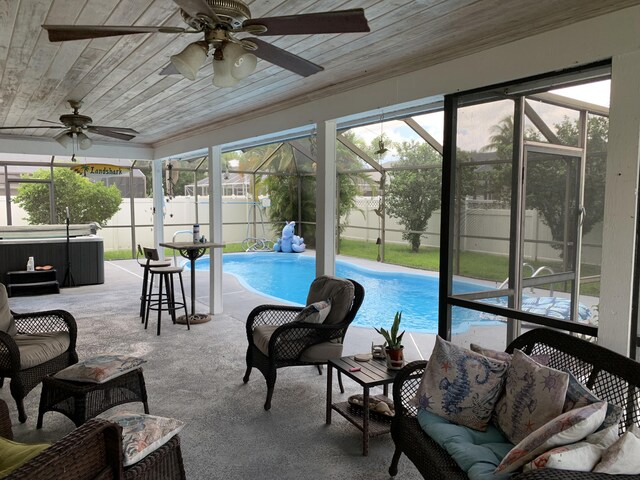 sunroom / solarium with ceiling fan and wooden ceiling