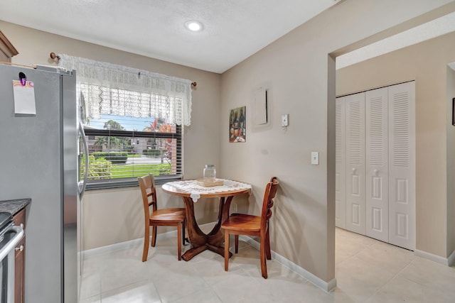 dining space featuring light tile patterned flooring