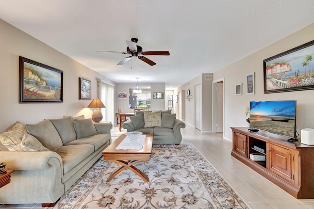 tiled living room with ceiling fan